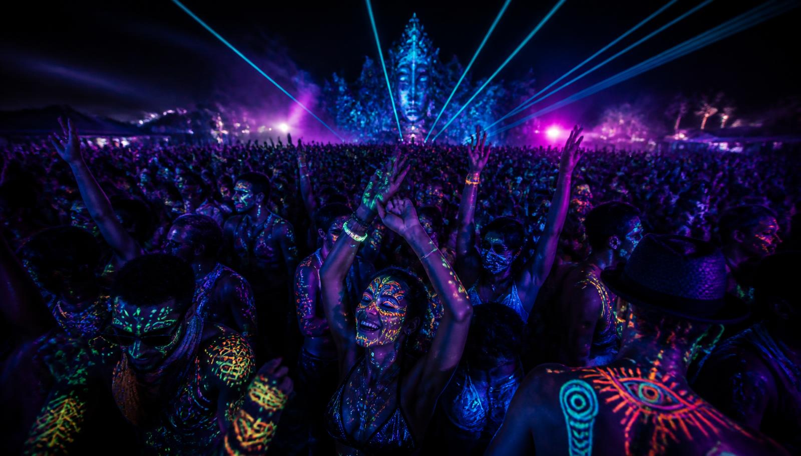 Festival crowd glowing with UV body paint